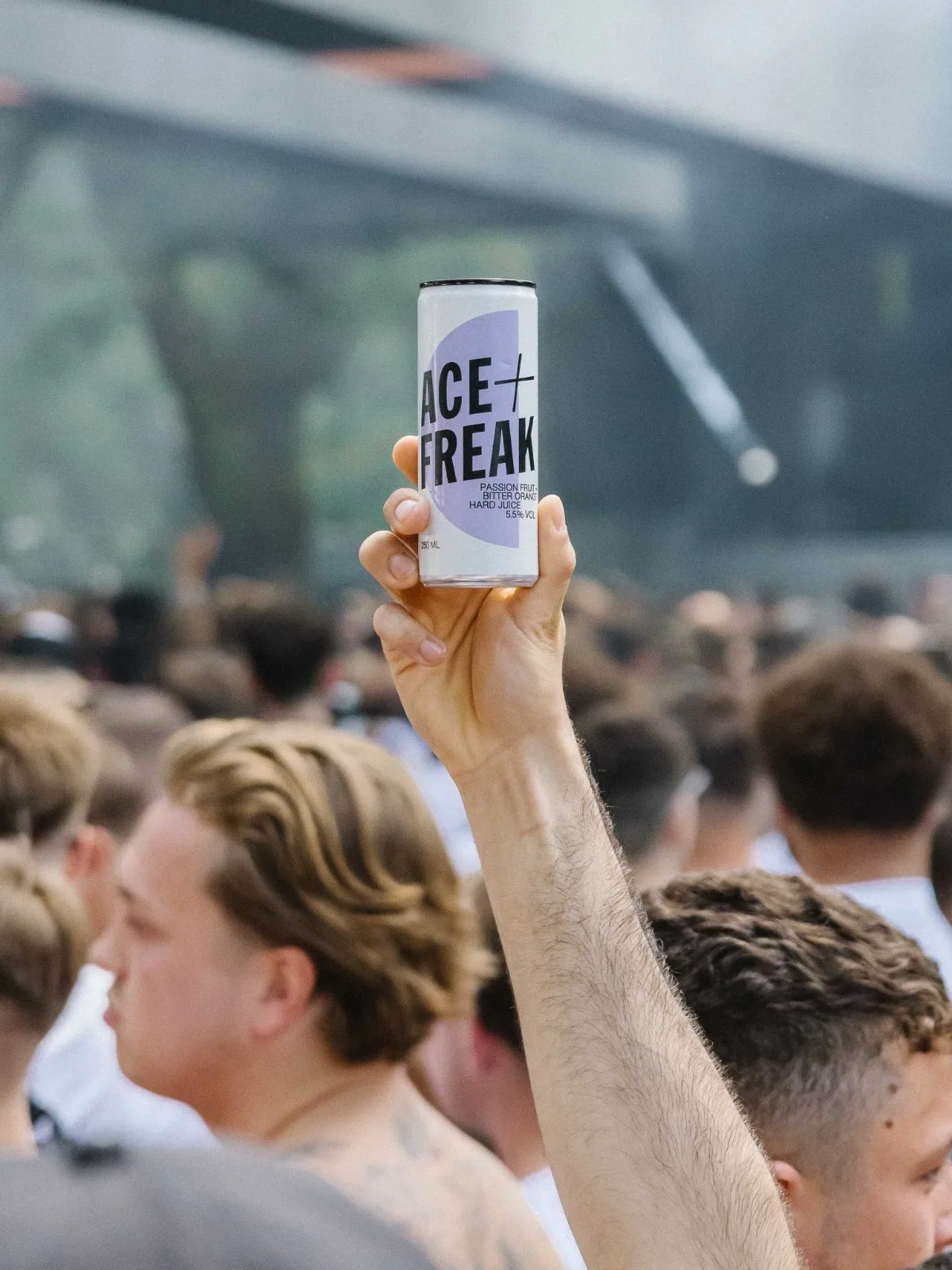 An Ace+Freak Hard Juice raised in a festival crowd